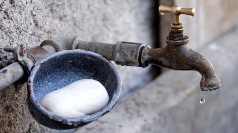 Dripping outside tap with soap dish