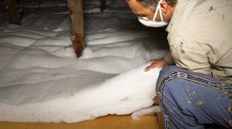 Man installing insulation