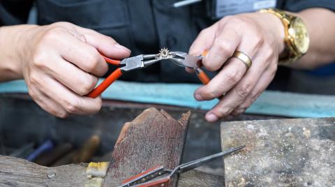 Person creating ring with pliers