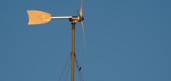 Small Wind Turbine Against Blue Sky