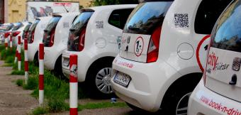 A row of white vehicles parked in a lot.