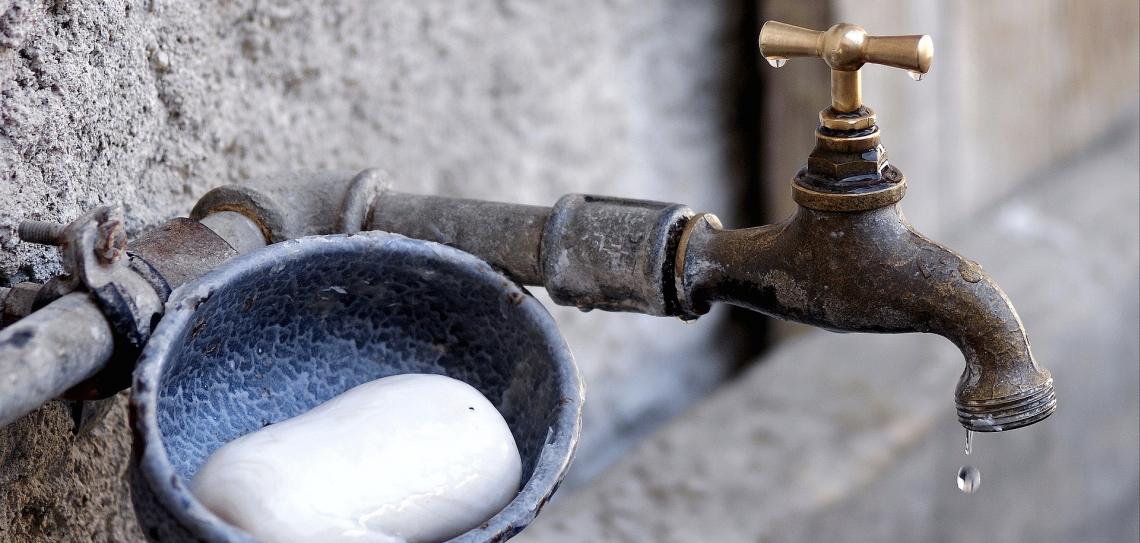 Dripping outside tap with soap dish