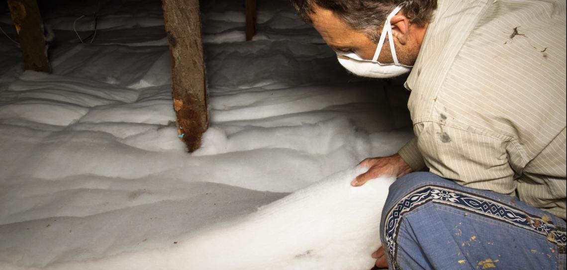 Man installing insulation