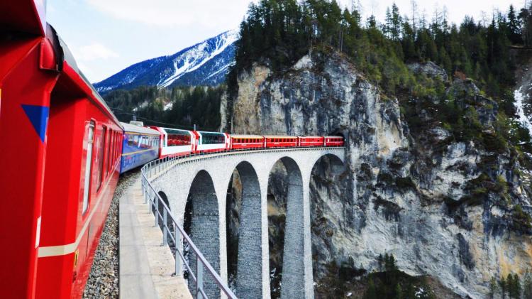 View from a train passing through beautiful mountain scenery