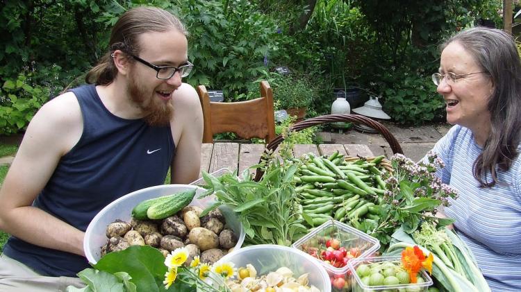 People enjoying the harvest from a forest garden