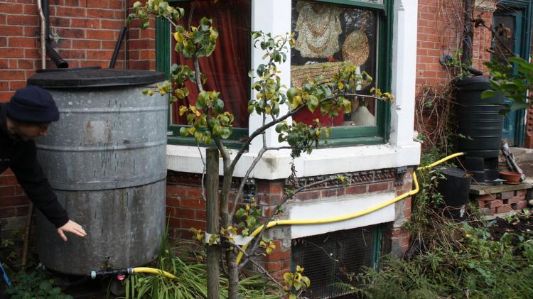 Capturing water from your roof which can then be used on your garden. Photo: Permaculture Association/Flickr Water butts outside of a terraced house