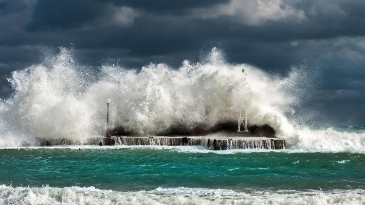 Large waves crashing over a jetty