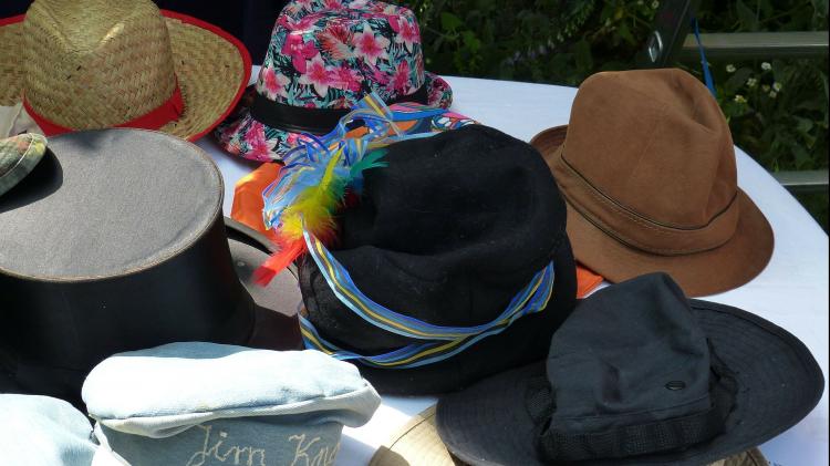 Swishing works like a giant clothes swap: you bring items you no longer wear and exchange them for something new-to-you. Photo: falco - Pixabay An assortment of hats sitting on a table
