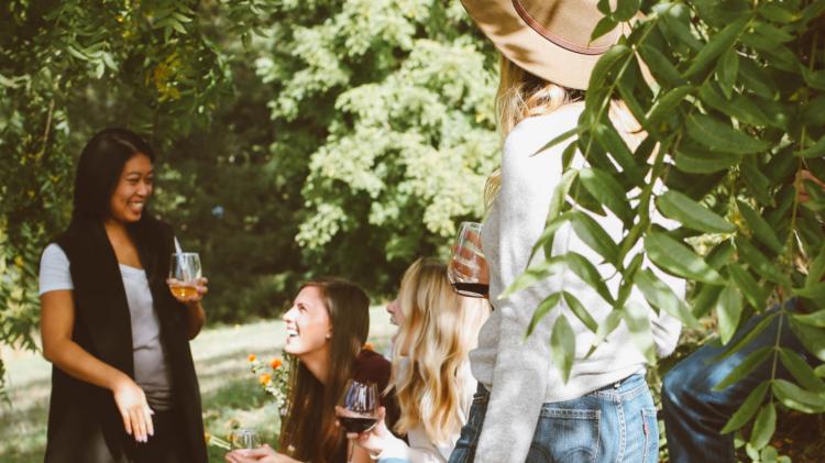 Get your friends, family and work colleagues round to admire what you've achieved, share food and drink. Photo: Kelsey Chance-Unsplash People gathered in the woods enjoying drinks