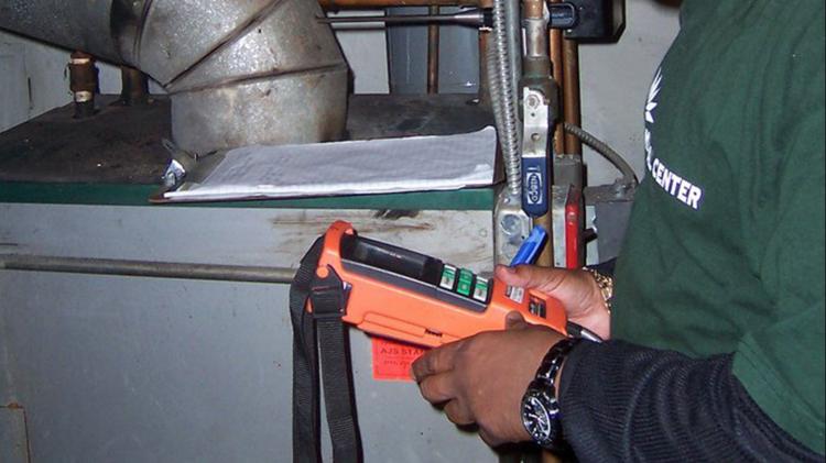 Man checking boiler with device