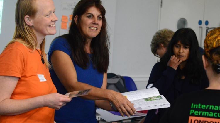 Two people talking and handing out information