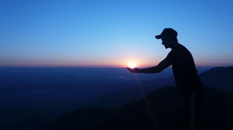 Photo: Babin Shrestha - unsplash.com Image of person holding the sunset.