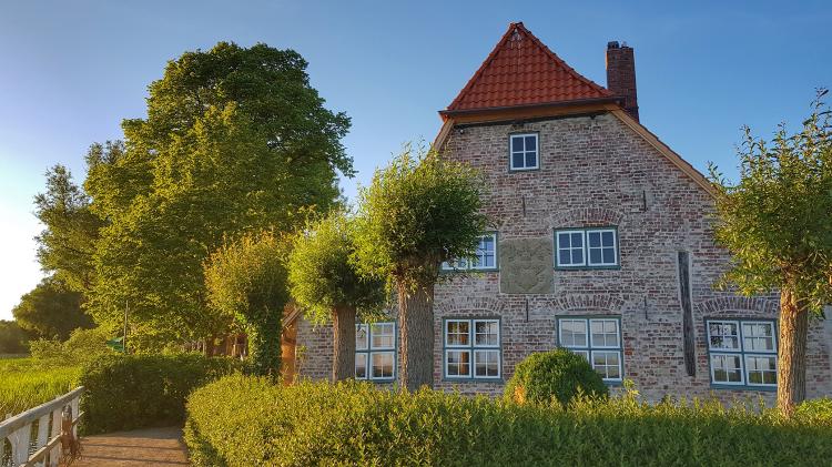 Brick house with trees outside and blue skies